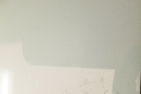 Surface Chip on White Quartz Countertop (Repaired)